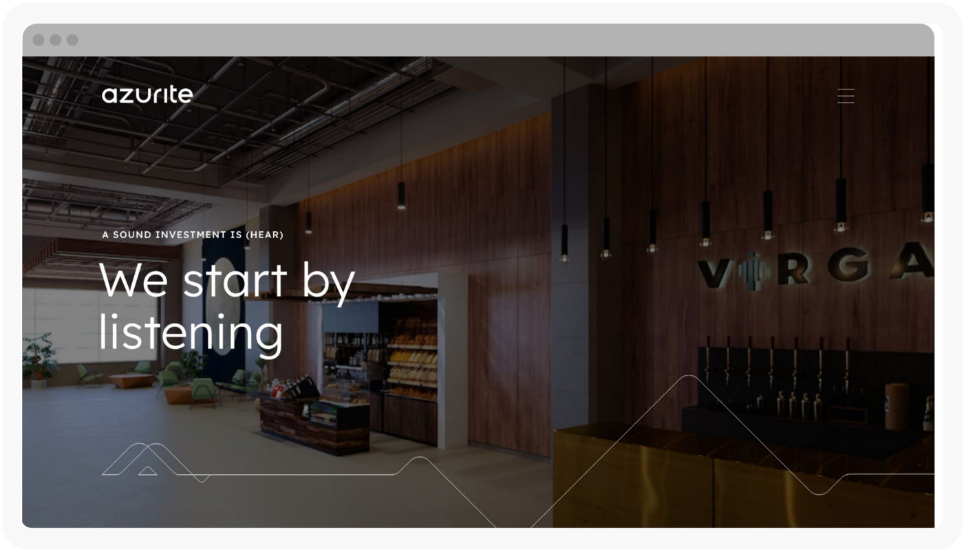 Modern office lobby with wood paneling, shelves with products, and a sign reading VIRGA. White text overlay says, We start by listening. Ceiling features exposed ducts and hanging lights.