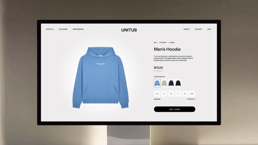 A computer screen displays an online store page for a blue mens hoodie, showing different color options, sizes, price of $70.00, and an Add to Bag button on the UNITUS website.