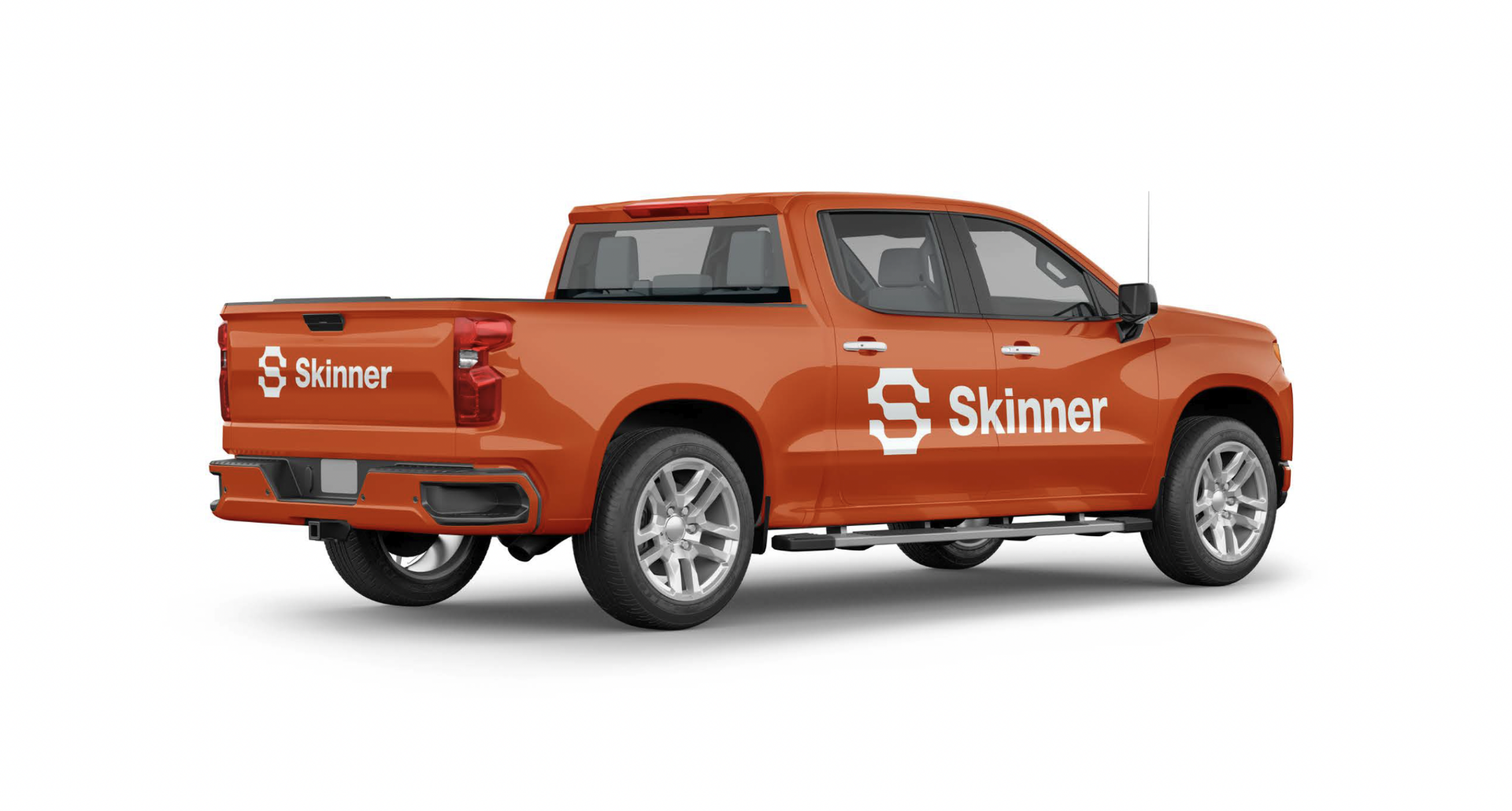 An orange pickup truck with silver wheels, displaying the word Skinner and a stylized S logo in white on the side and tailgate, viewed from the rear passenger side.