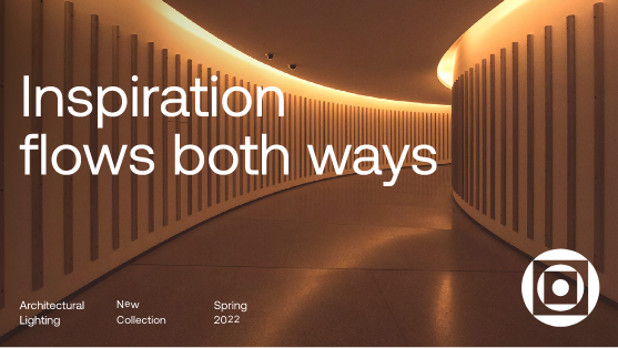 Curved hallway with vertical light panels on the walls, glowing with warm light. Large text reads, Inspiration flows both ways. Bottom left notes Architectural Lighting, New Collection, Spring 2022. Logo on bottom right.