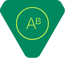 A green triangular sign with rounded corners featuring a yellow circle in the center. Inside the circle, the letters A and a smaller B appear in yellow.