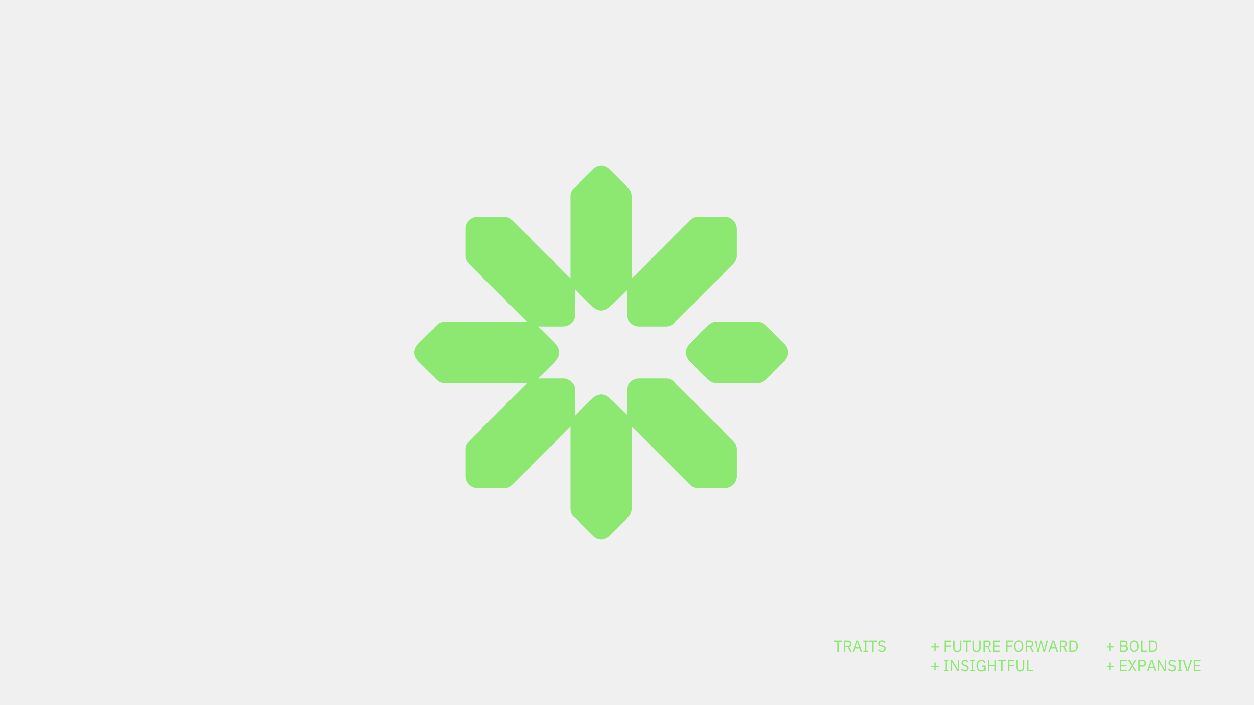 A green geometric starburst symbol on a light grey background. In the bottom right corner, small green text reads: TRAITS + FUTURE FORWARD + BOLD + INSIGHTFUL + EXPANSIVE.