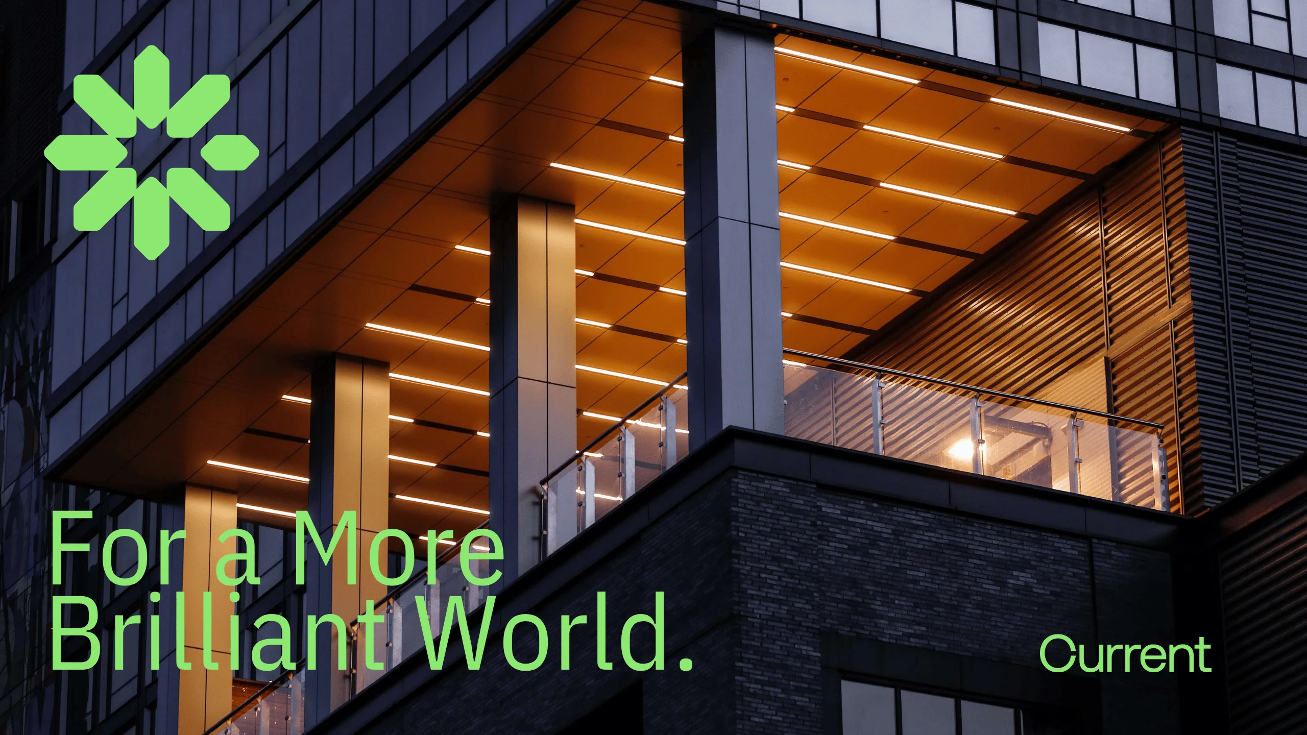 Modern building at night with warm, illuminated ceiling lights. Green geometric logo in the upper left, and text reads For a More Brilliant World. and Current in bright green at the bottom.