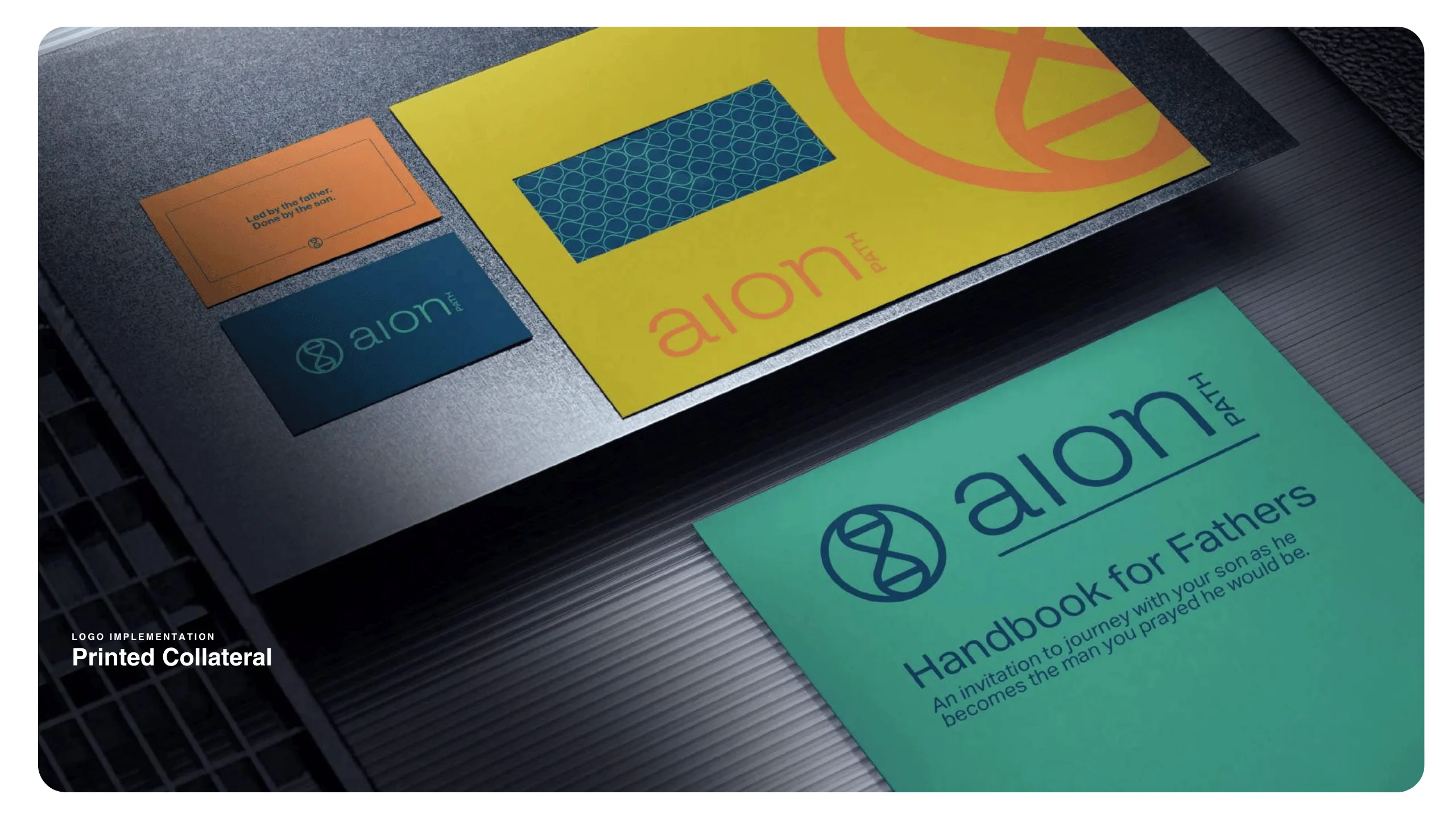 A display of branded printed materials, including business cards and booklets, featuring the aion path logo and modern designs in teal, yellow, and orange, with one card titled Handbook for Fathers.