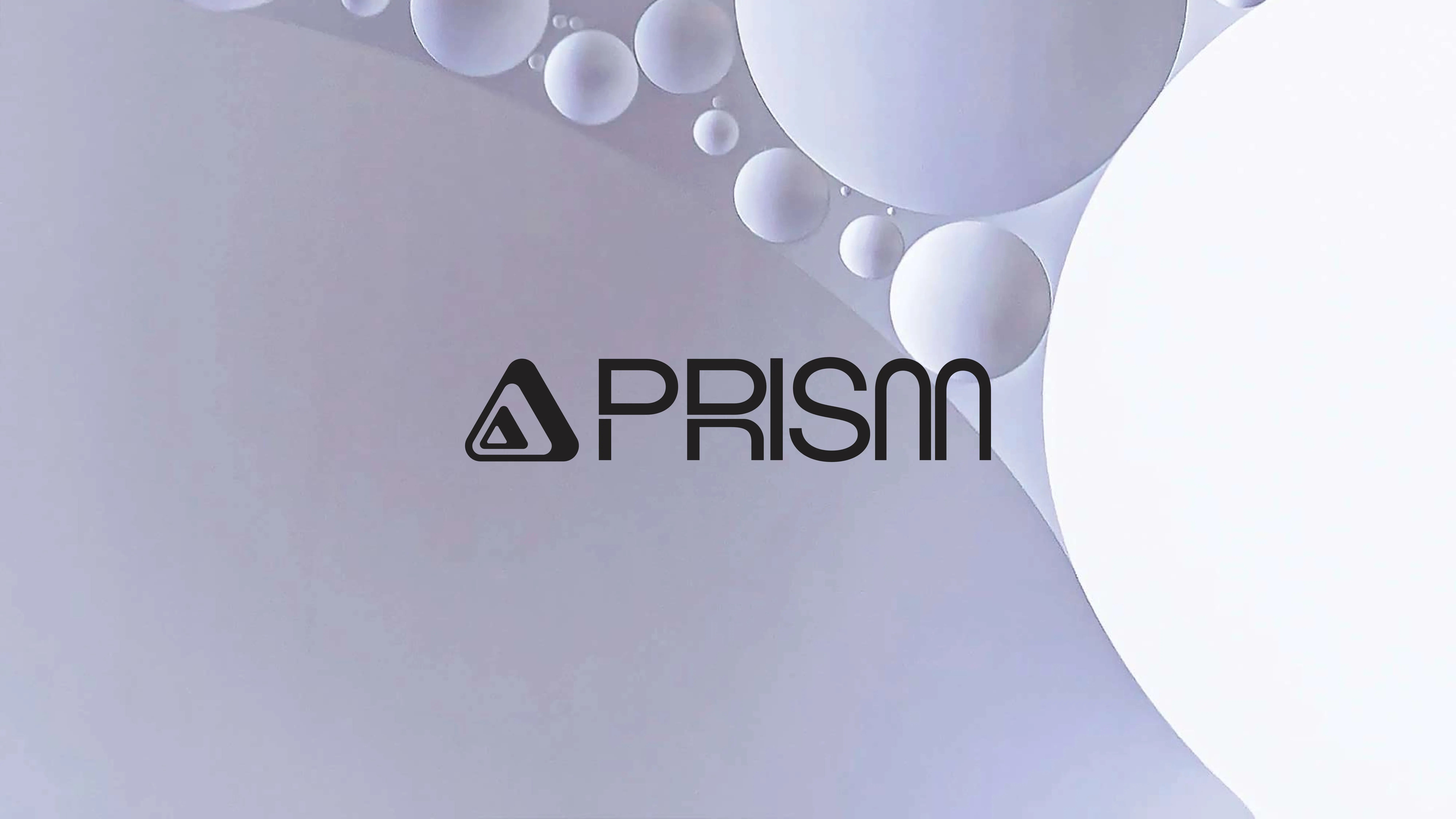A minimalist graphic with overlapping white and light gray spheres of various sizes. At the center, the word PRISM and a triangle logo appear in bold black text.