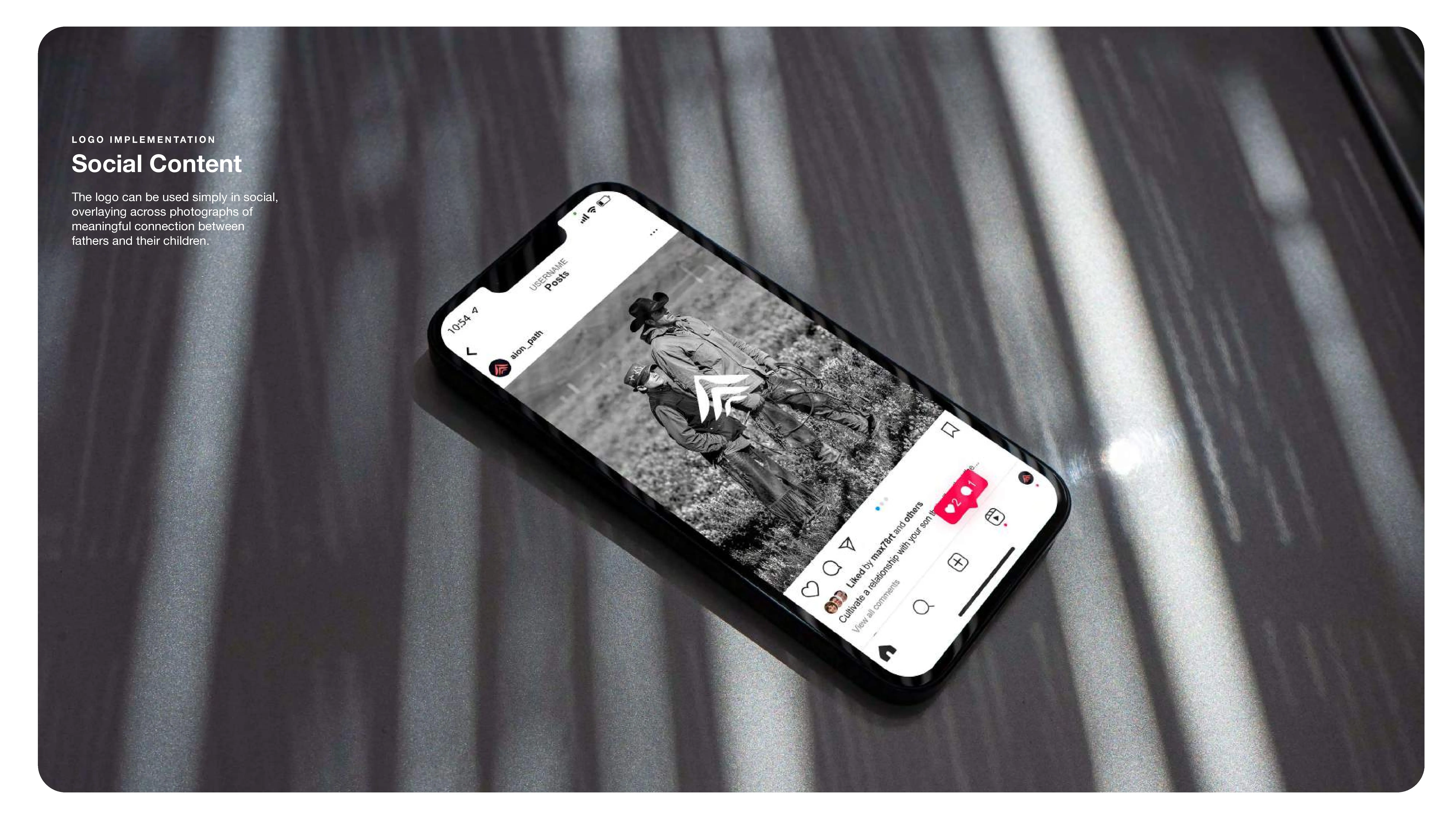 A smartphone displaying a black-and-white Instagram post of a parent and child sitting outdoors, placed on a reflective surface with light and shadow patterns. Text on the left reads Social Content with a brief description below.