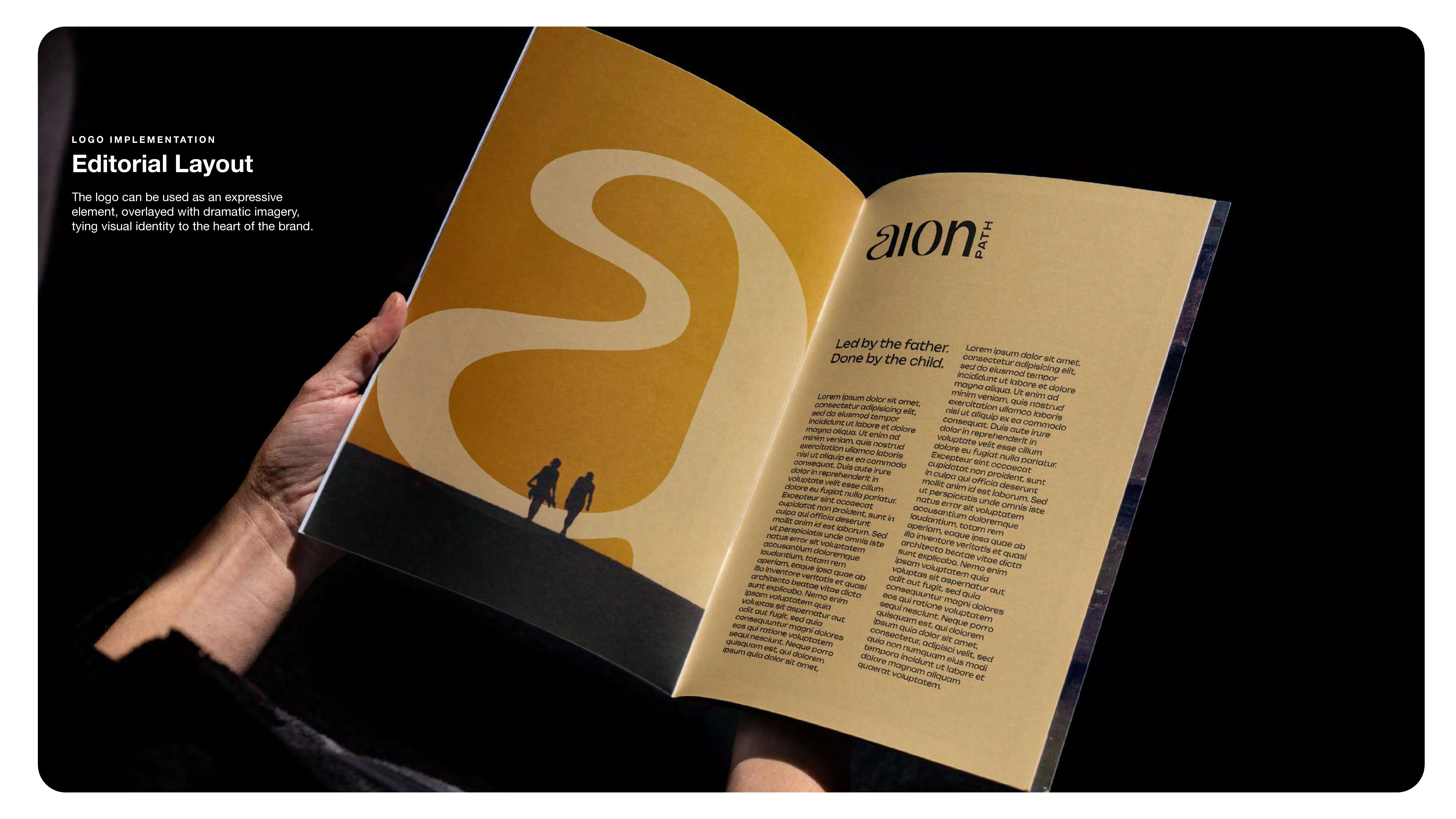 A person holds open a magazine featuring an editorial layout with bold, abstract yellow artwork on the left page and a large block of text with the heading aion on the right page.