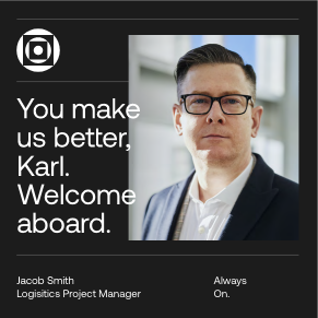 A man in glasses and a suit stands indoors. Text reads: You make us better, Karl. Welcome aboard. Below, it says Jacob Smith, Logistics Project Manager and Always On. A circular logo is in the top left corner.